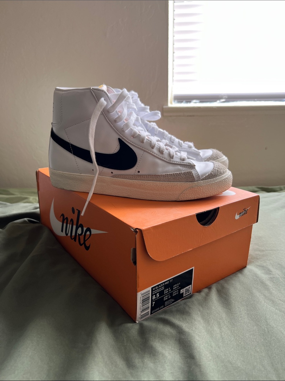 Nike White High-Top Sneakers with Black Swoosh